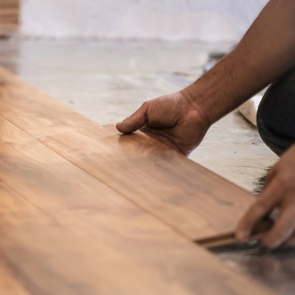 worker laying floor planks